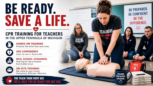 Teacher practicing CPR chest compressions on a training manikin during a hands-on CPR class in a classroom setting in the Upper Peninsula of Michigan, with AED training equipment and other educators observing.